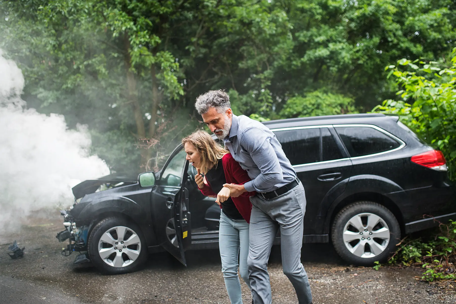 man helping a woman involved in car accident